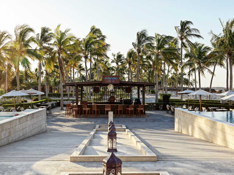 photo for the pool bar at fanar hotel and the palm trees around at Hawana Salalah Oman